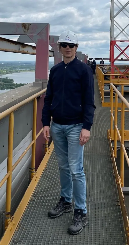 Professor Tom Measham at power plant, standing on bridge