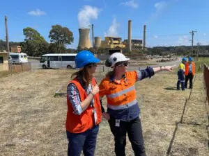 Rebecca Rey and Cassandra Tolsma in high-vis looking at mine site